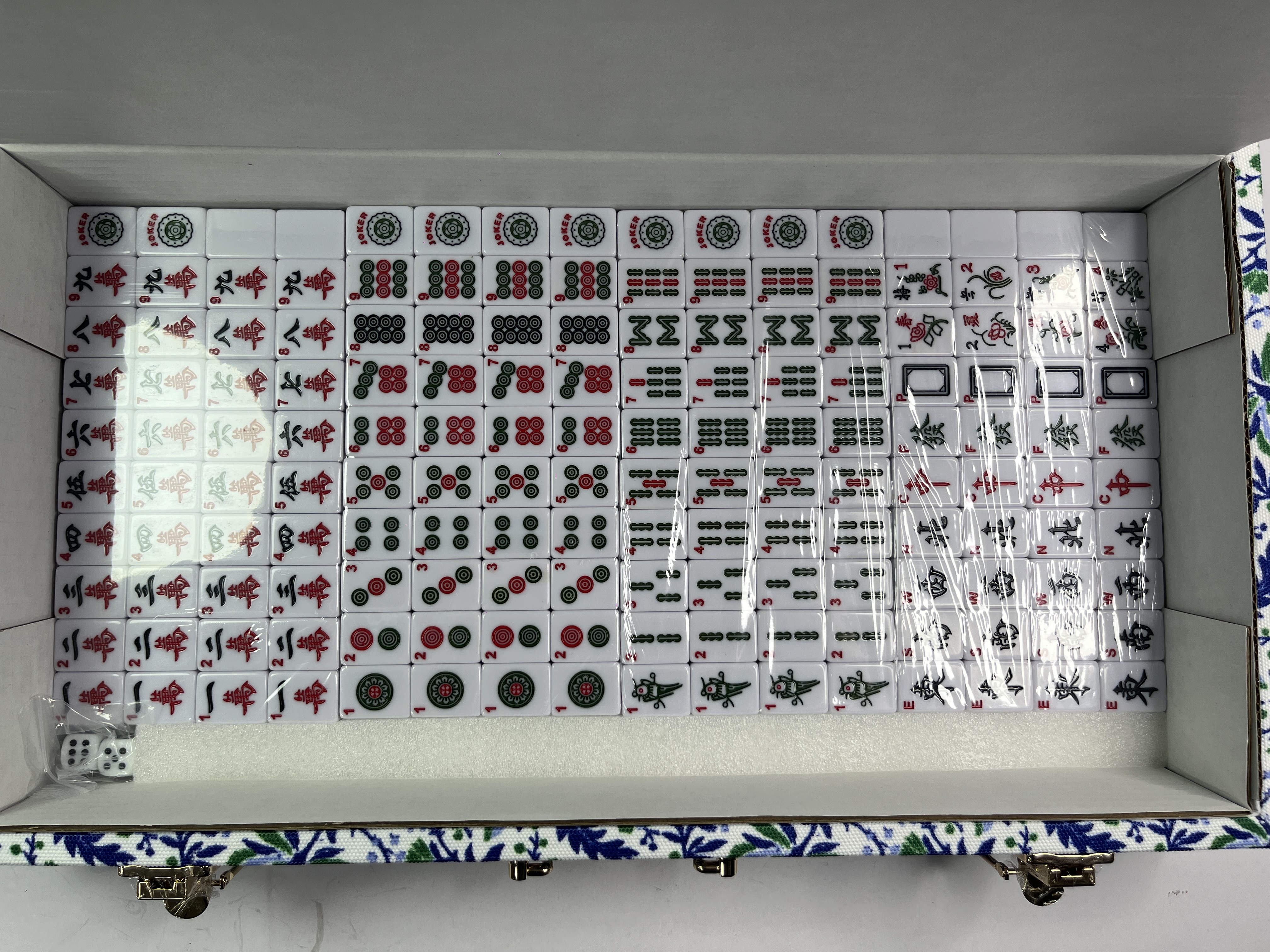 Close view of American mahjong tiles showing engraved faces and thickness